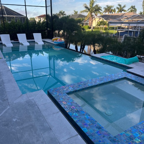 A customer's pool and spa with iridescent mosaic tile, cleaned by Platinum Pools